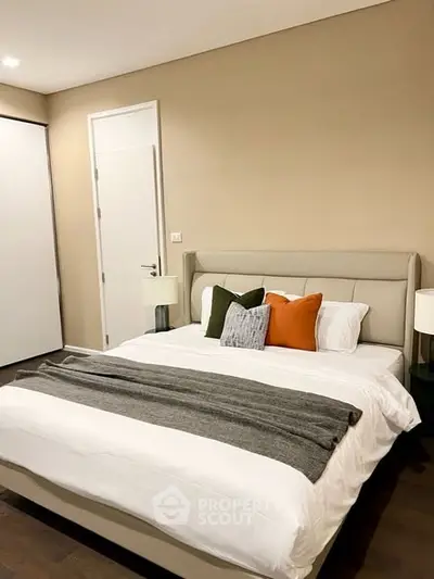 Cozy bedroom with modern decor and plush bedding in a stylish apartment.
