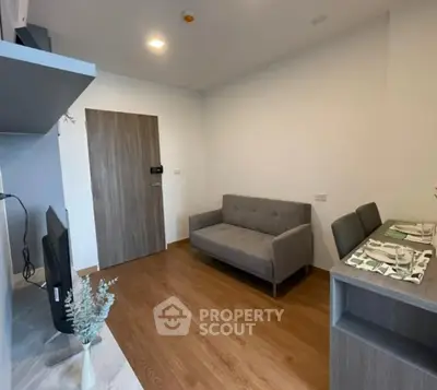 Modern living room with sleek furniture and wooden flooring