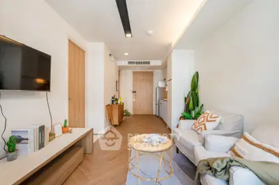 Modern living room with cozy seating and stylish decor in a contemporary apartment.