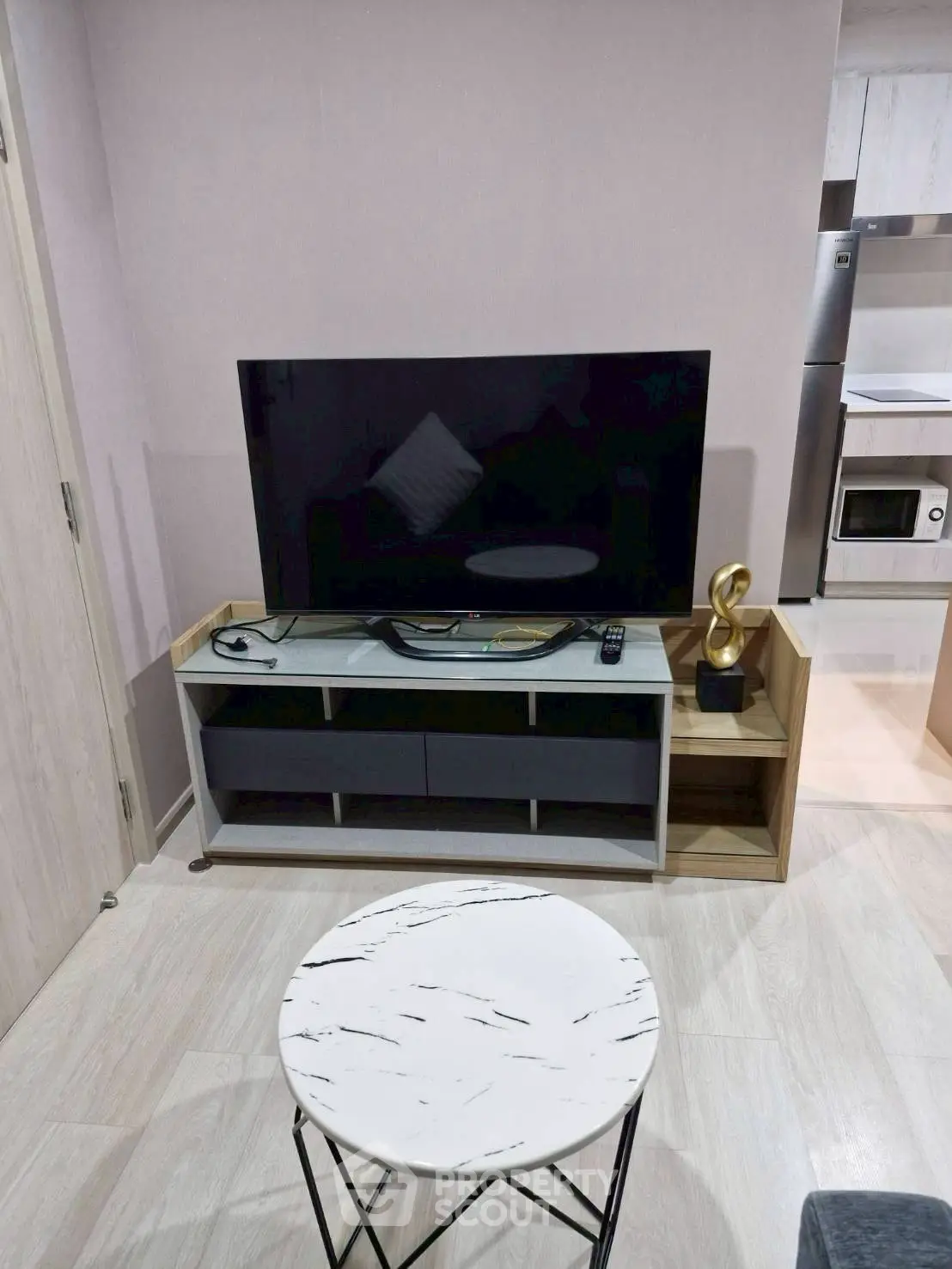 Modern living room with sleek TV stand and marble coffee table