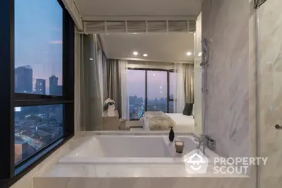 Luxurious bathroom with city view and modern bathtub in high-rise apartment.