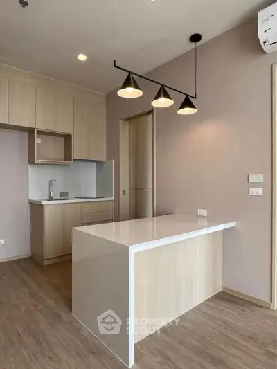 Modern minimalist kitchen with sleek cabinetry and island in open layout