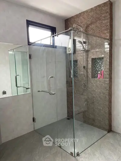 Modern bathroom with glass shower enclosure and stylish tile design