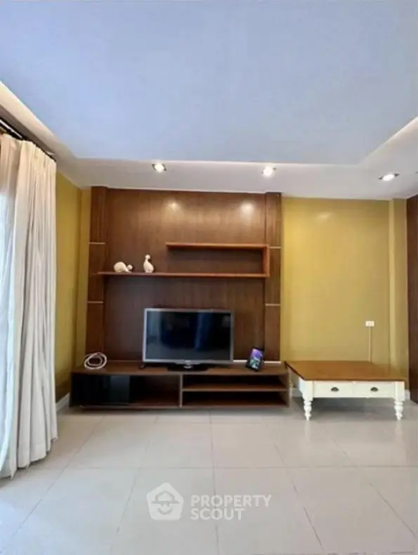 Spacious living room with modern TV setup and elegant decor