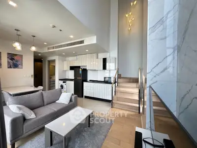 Modern open-plan living room with stylish kitchen and staircase in luxury apartment