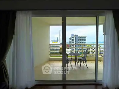 Spacious balcony with stunning city and ocean view, perfect for relaxation and outdoor dining.