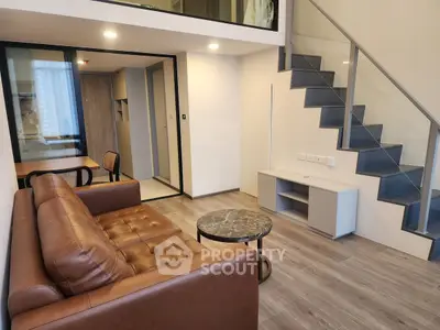 Modern duplex living room with stylish staircase and leather sofa