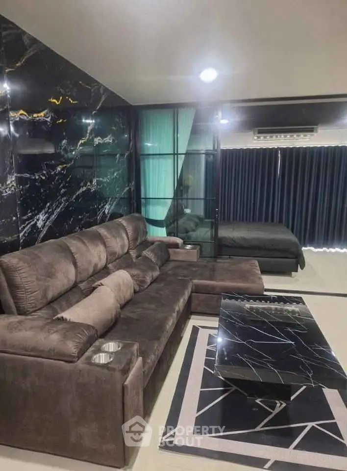 Luxurious modern living room with plush sofa and marble accents