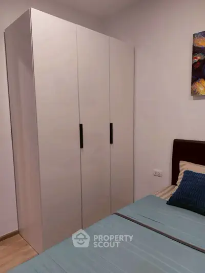 Modern bedroom with sleek wardrobe and stylish bedding