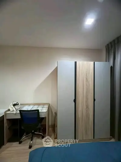 Modern bedroom with study desk and wardrobe, perfect for comfortable living.