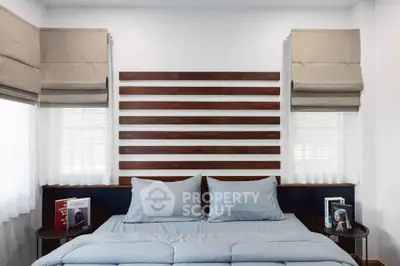 Modern bedroom with stylish headboard and cozy bedding