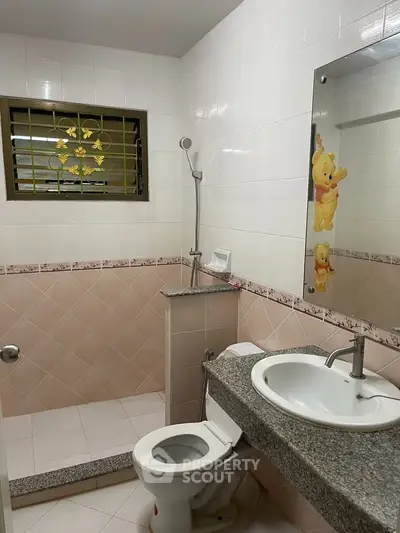 Charming bathroom with playful decor and modern fixtures, perfect for a cozy home.