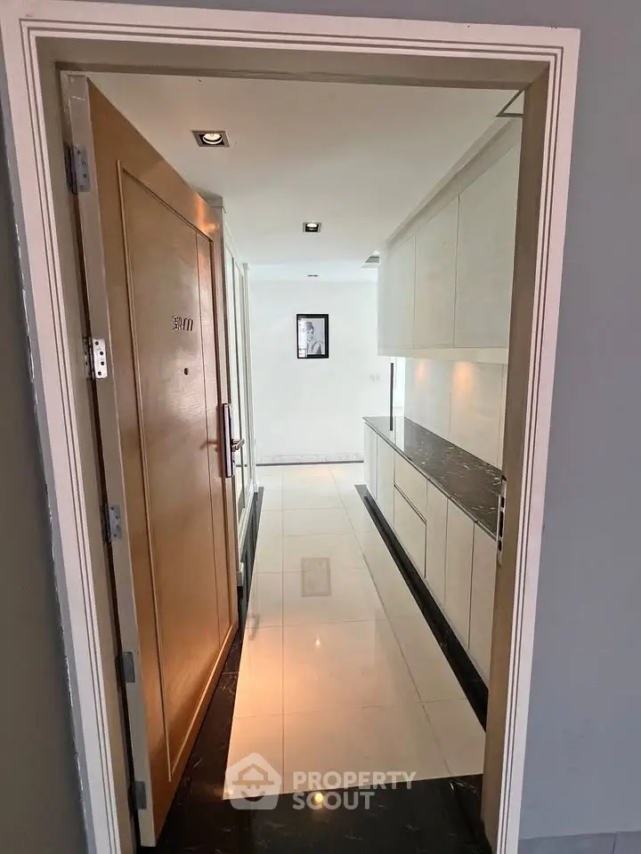 Modern apartment entrance with sleek hallway and elegant cabinetry