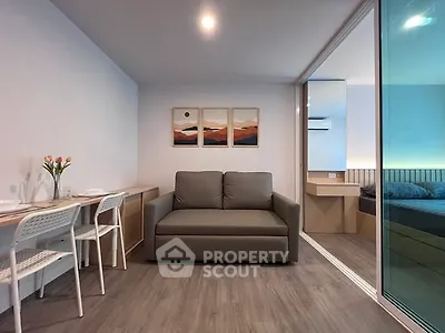 Modern living room with cozy sofa and stylish decor in open-plan apartment.