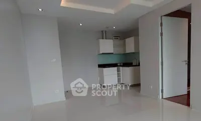 Modern minimalist kitchen with sleek cabinetry and open layout in a bright apartment.