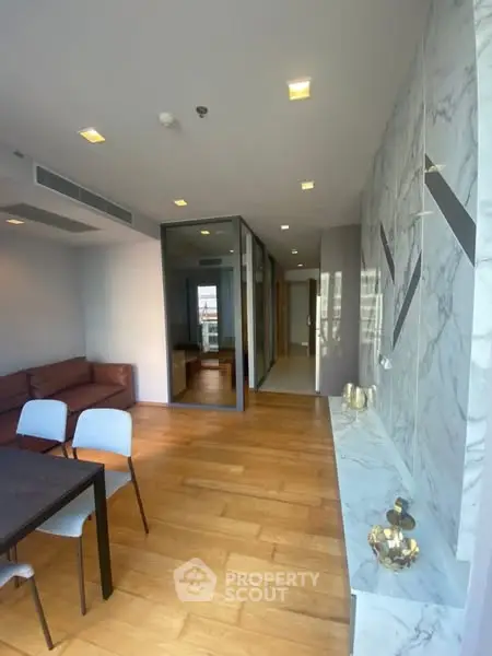 Modern living room with marble accents and wooden flooring