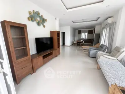Spacious modern living room with elegant wooden furniture and open layout kitchen.