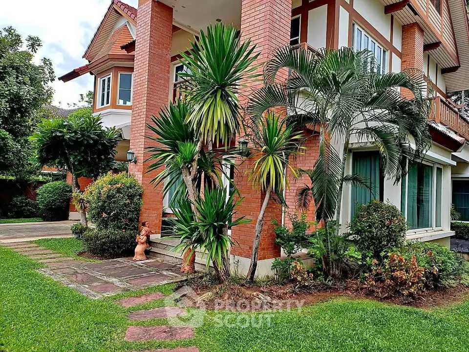 Charming brick exterior house with lush garden and pathway