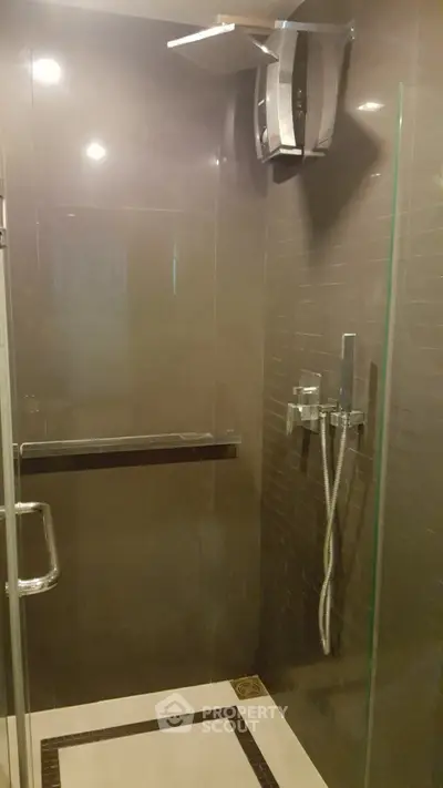 Modern bathroom with glass shower enclosure and sleek fixtures