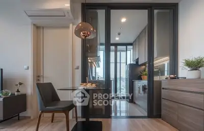 Modern kitchen with sleek design and open layout, featuring stylish lighting and contemporary furniture.