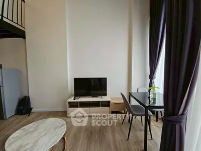 Modern living room with high ceiling and stylish decor in a contemporary apartment.