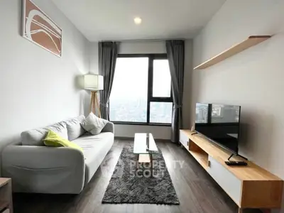 Modern living room with city view, sleek furniture, and stylish decor
