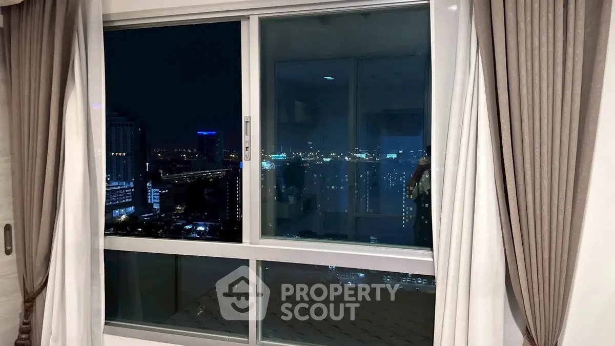 Stunning city view from modern apartment window at night