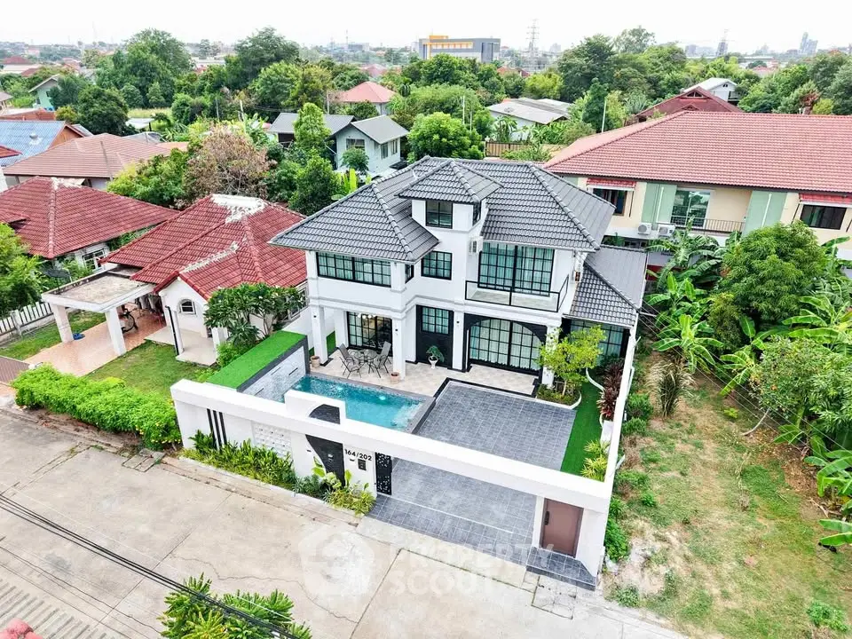 Stunning two-story modern home with lush garden and spacious driveway in a serene neighborhood.