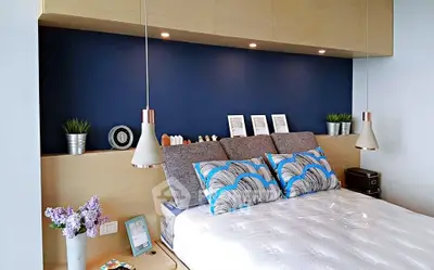 Modern bedroom with stylish decor and cozy ambiance, featuring elegant lighting and contemporary furnishings.
