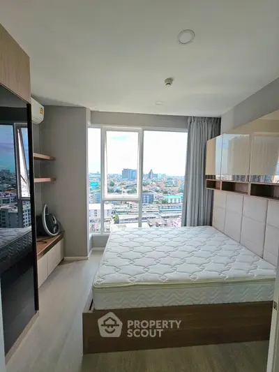 Modern bedroom with city view, featuring sleek design and ample natural light.