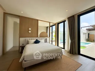 Luxurious bedroom with pool view and modern design in a serene setting.