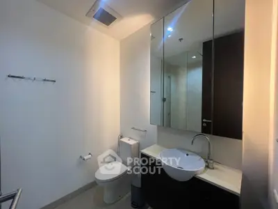Modern bathroom with sleek fixtures and ample lighting, perfect for a contemporary home.