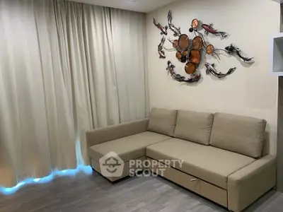 Modern living room with stylish beige sofa and artistic wall decor, perfect for cozy relaxation.