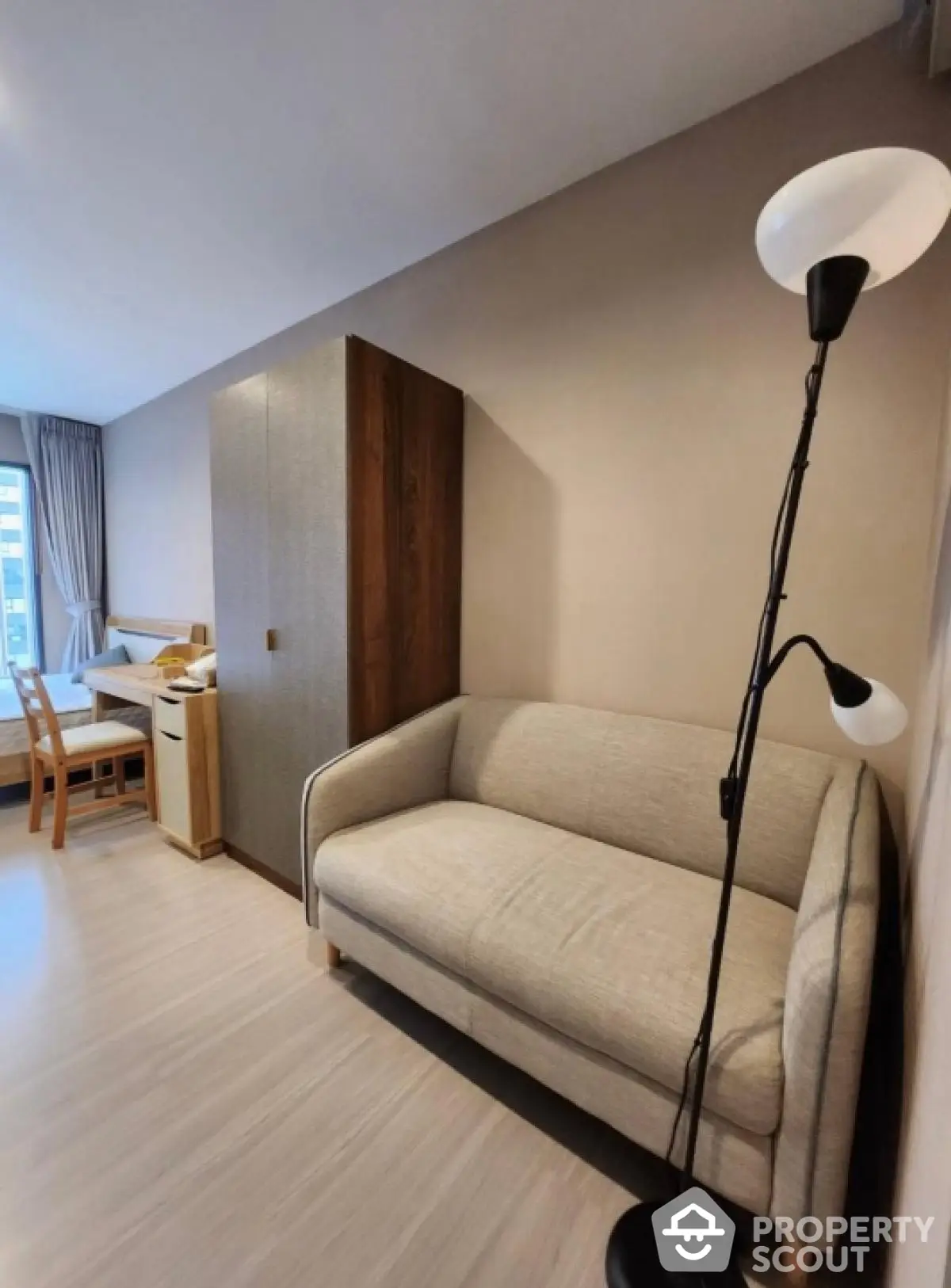 Modern living room with cozy sofa and stylish floor lamp in a bright apartment.