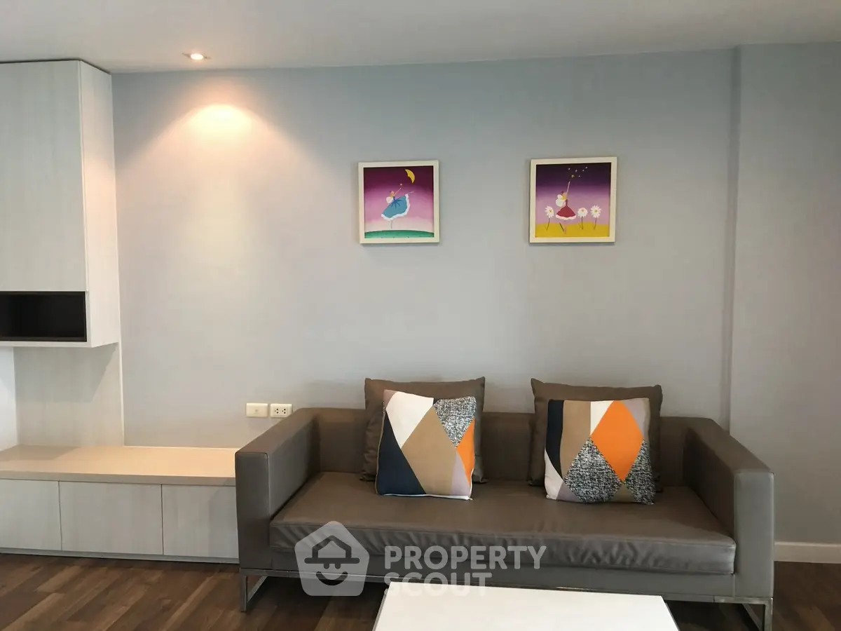 Modern living room with stylish sofa and abstract art on the wall.