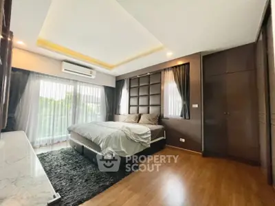 Luxurious bedroom with modern decor, large windows, and elegant lighting, perfect for relaxation and comfort.