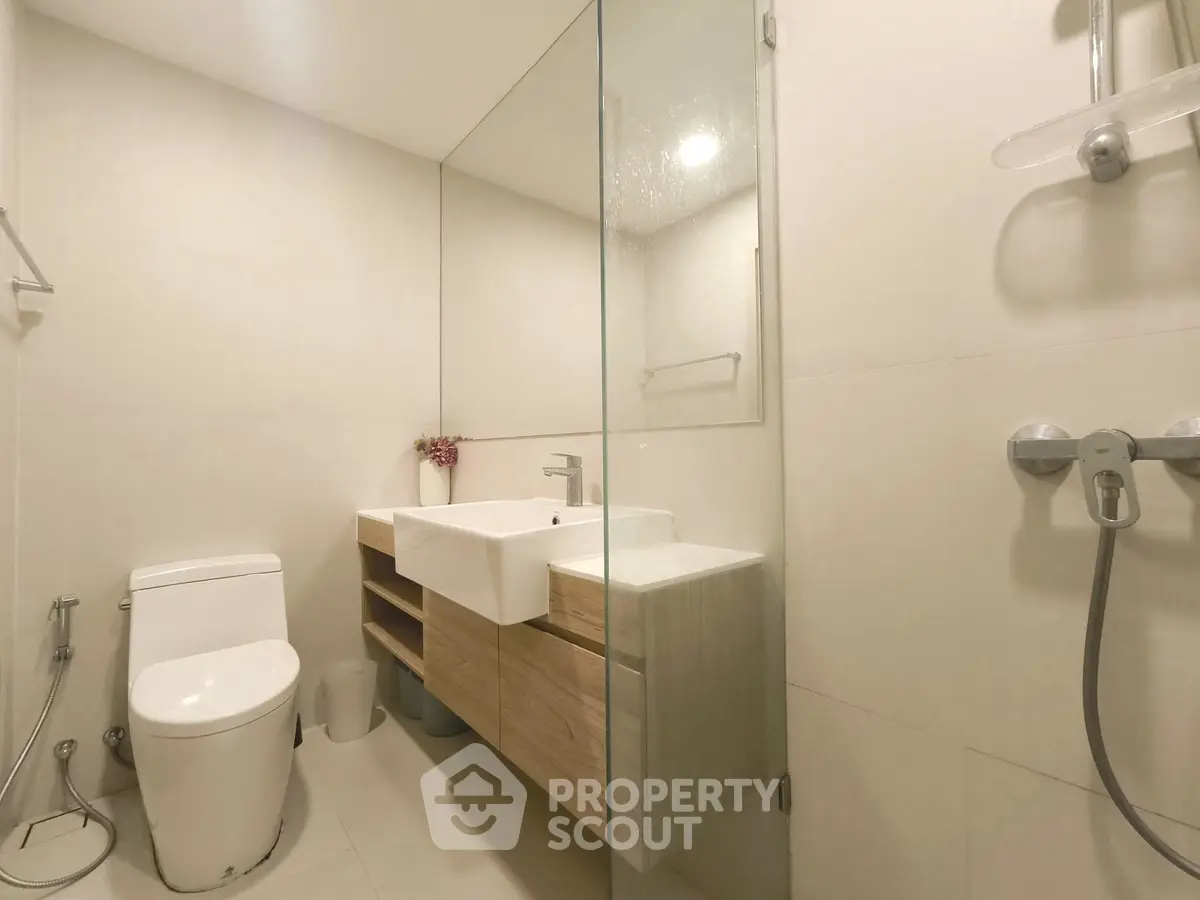 Modern bathroom with sleek fixtures and glass shower enclosure