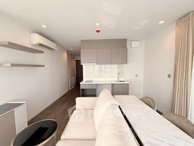 Modern open-layout living room with sleek kitchen and elegant dining area