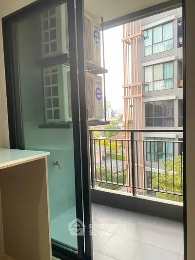 Modern apartment balcony with city view and air conditioning units, perfect for urban living.