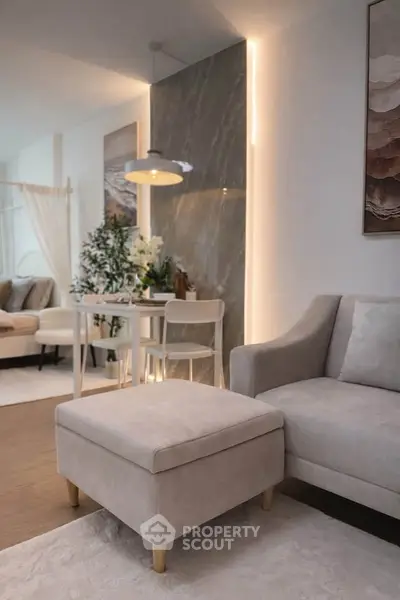 Modern living room with stylish furniture and ambient lighting, perfect for cozy gatherings.