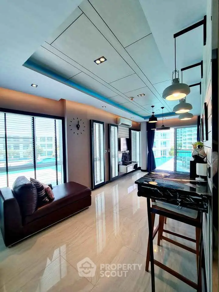Modern living room with large windows and stylish decor in a luxury apartment.