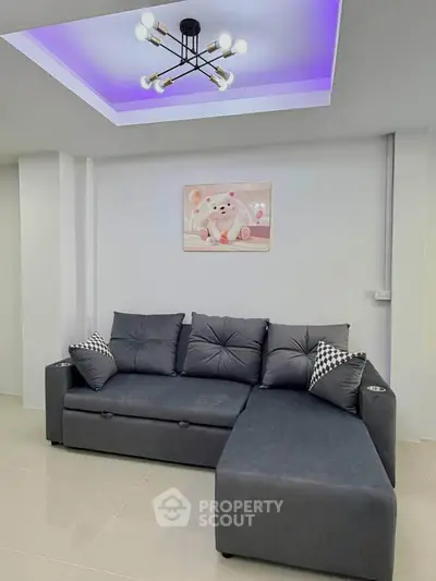 Modern living room with stylish L-shaped sofa and chic ceiling lighting