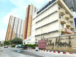 Modern urban residential buildings with City Home sign, showcasing vibrant city living.