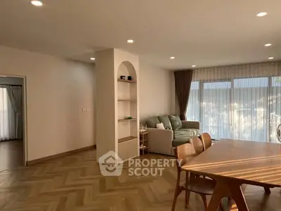 Spacious living room with elegant dining area and natural light