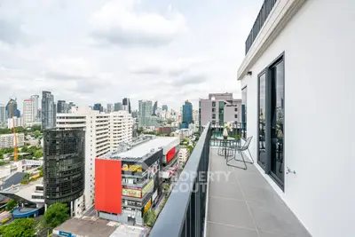 Stunning cityscape view from modern high-rise balcony with sleek design.