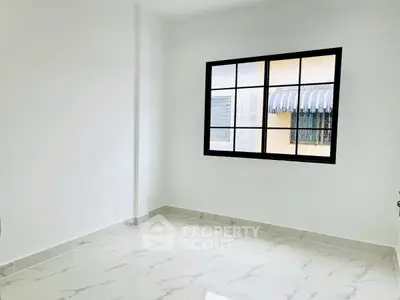 Bright empty room with large window and marble floor tiles