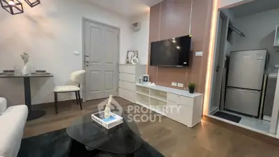 Modern living room with sleek TV setup and cozy dining area