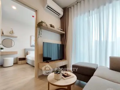 Modern living room with sleek TV setup and cozy bedroom view