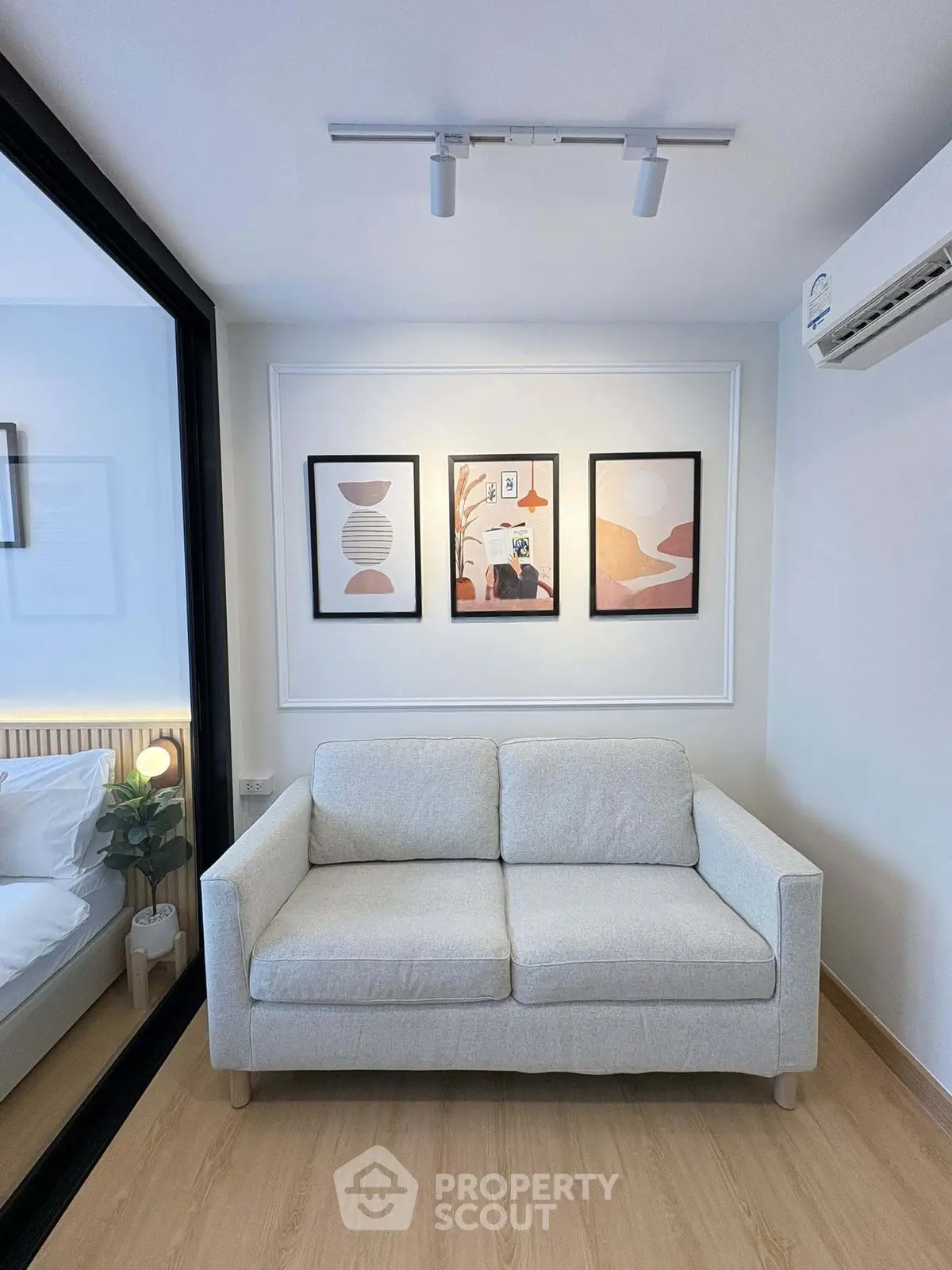 Modern living room with stylish sofa and contemporary wall art in a cozy apartment setting.