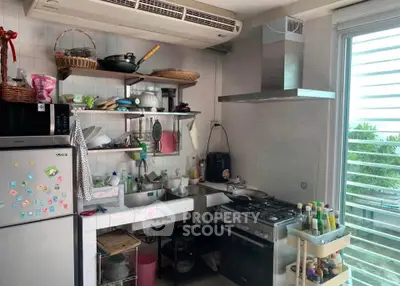 Charming kitchen with gas stove and open shelving, perfect for culinary enthusiasts.